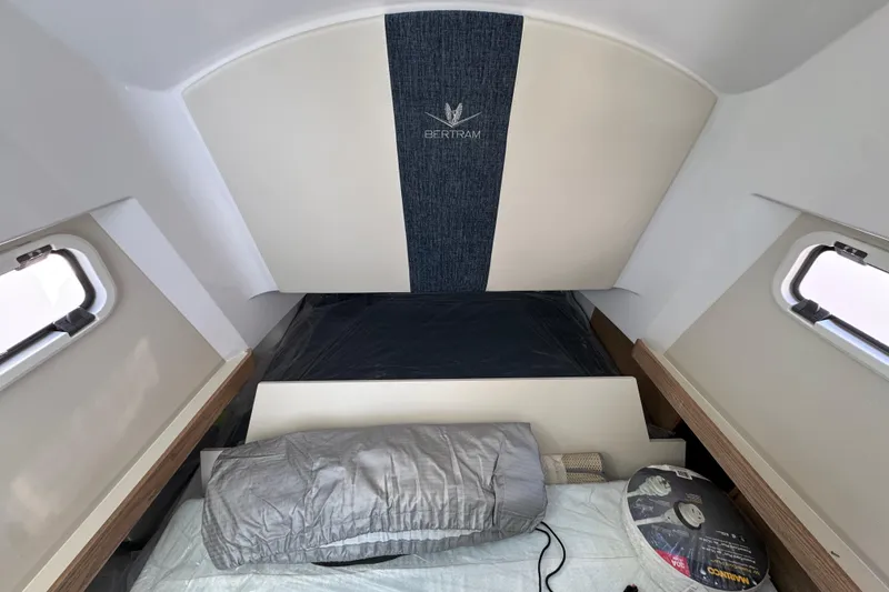 Slide: The Image of Interior cabin of 2026 Bertram 34 CC boat with bedding and windows. - 37