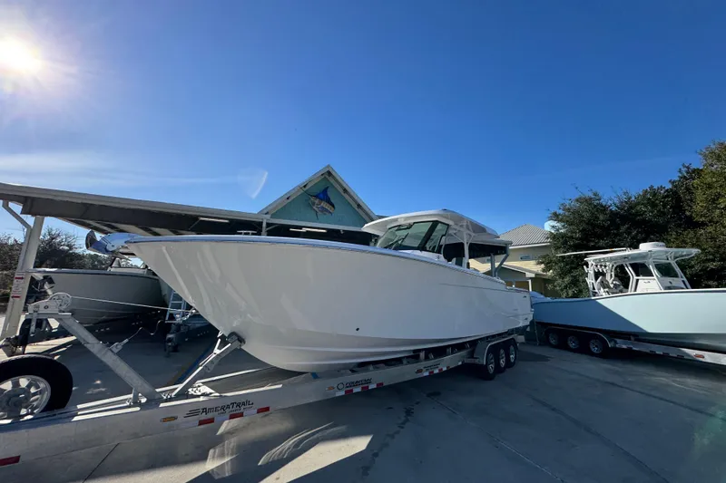Slide: The Image of 2026 Bertram 34 CC boat on trailer under clear blue sky. - 4