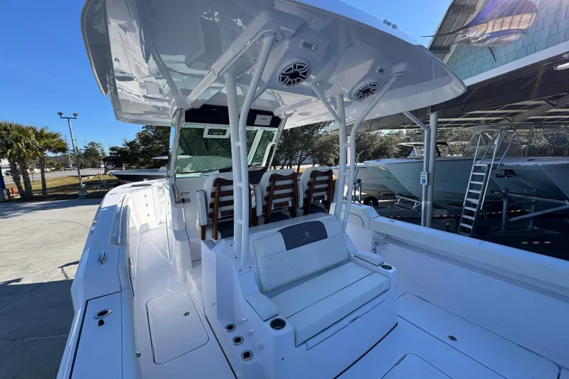 Slide: The Image of 2026 Bertram 34 CC boat interior with seating and canopy, docked outdoors. - 41