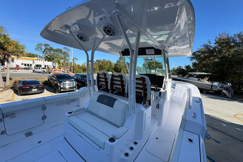Slide: The Image of 2026 Bertram 34 CC boat interior with seating and console, parked outdoors. - 43