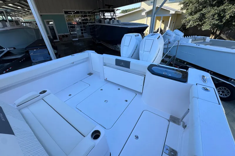 Slide: The Image of 2026 Bertram 34 CC boat interior with seating and Mercury engines in a showroom. - 45
