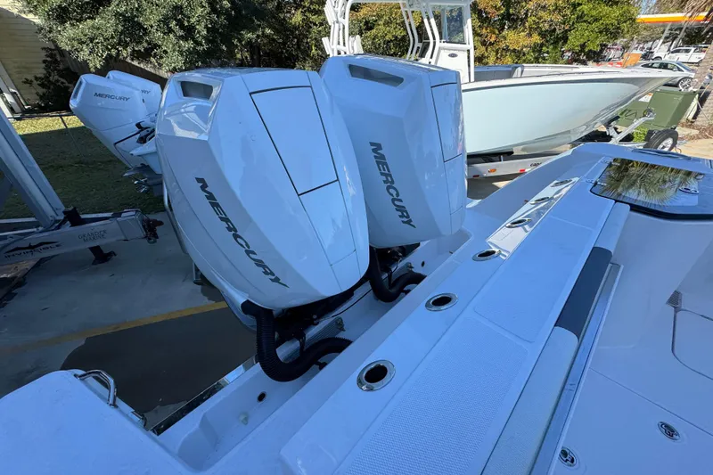 Slide: The Image of 2026 Bertram 34 CC boat with dual Mercury outboard engines, parked outdoors. - 48