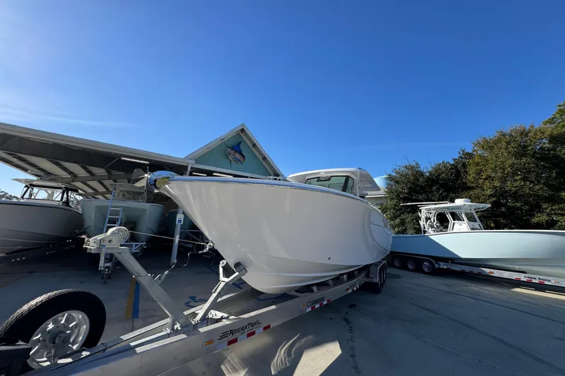 Slide: The Image of 2026 Bertram 34 CC boat on trailer under clear blue sky. - 5