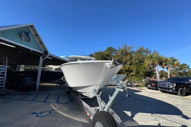 Slide: The Image of 2026 Bertram 34 CC boat on trailer in sunny outdoor setting. - 8