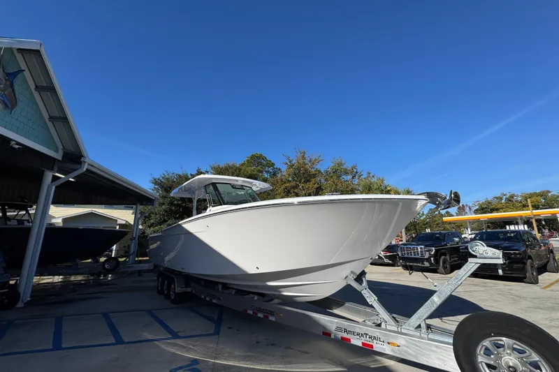 Slide: The Image of 2026 Bertram 34 CC boat on trailer under clear blue sky. - 9