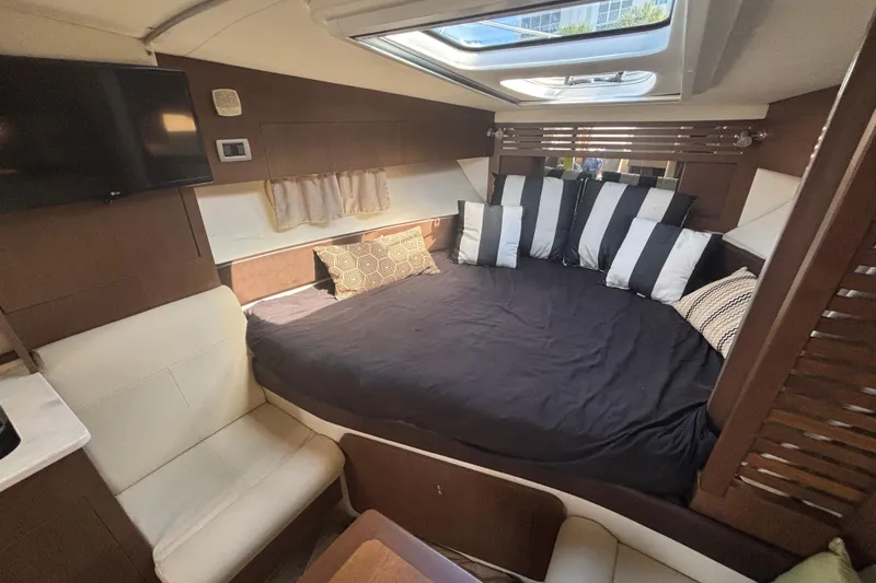 Slide: The Image of Luxurious interior of 2017 Sea Ray 310 Sundancer with cozy bed and modern decor. - 15