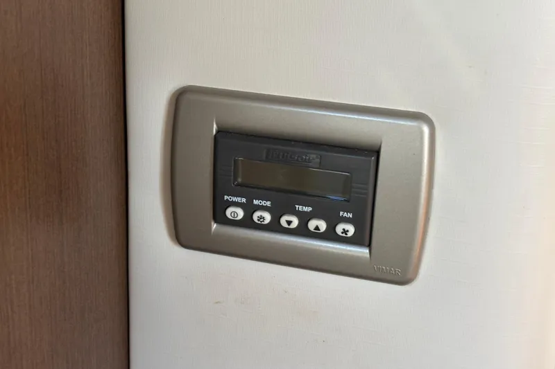 Slide: The Image of Control panel on 2017 Sea Ray 310 Sundancer boat, featuring power, mode, temperature, and fan settings. - 19