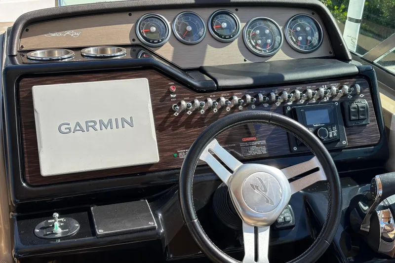 Slide: The Image of 2017 Sea Ray 310 Sundancer dashboard with Garmin navigation and control panel. - 7