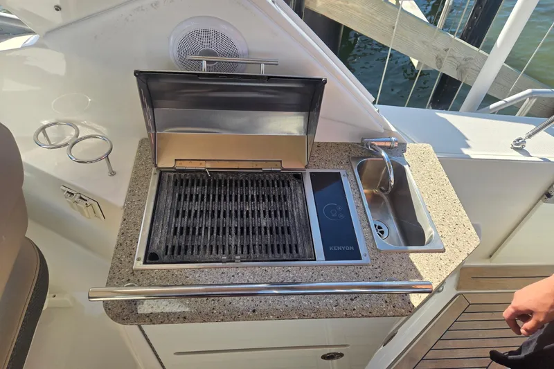 Slide: The Image of Outdoor kitchen on 2017 Sea Ray 310 Sundancer yacht with grill and sink. - 9