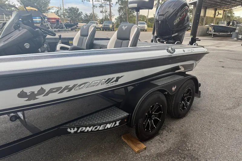 Slide: The Image of 2025 Phoenix 919 ZXL boat on trailer, featuring sleek design and modern seating. - 2