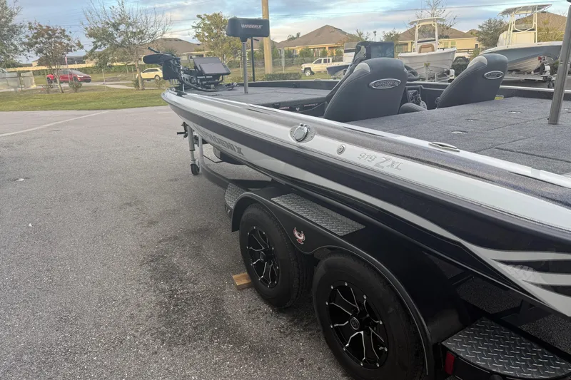Slide: The Image of 2025 Phoenix 919 ZXL boat on trailer, parked outdoors, showcasing sleek design and modern features. - 3