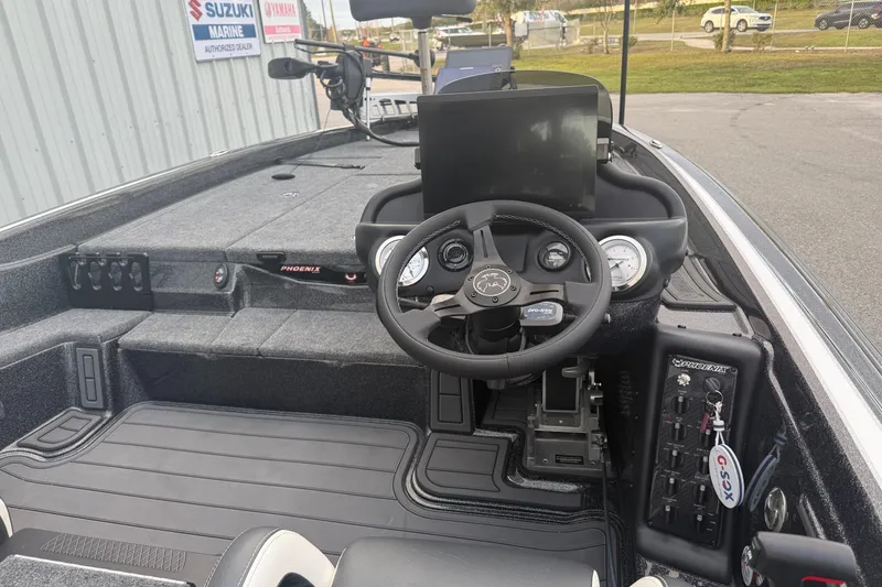 Slide: The Image of Interior of 2025 Phoenix 919 ZXL boat with steering wheel and control panel. - 9
