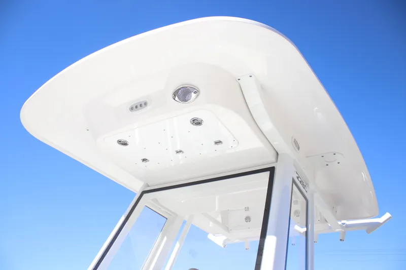 Slide: The Image of 2026 Sea Fox 228 Commander boat top against clear blue sky. - 13