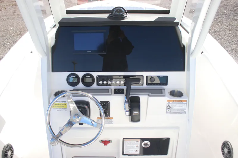 Slide: The Image of 2026 Sea Fox 228 Commander boat dashboard with steering wheel and controls. - 16