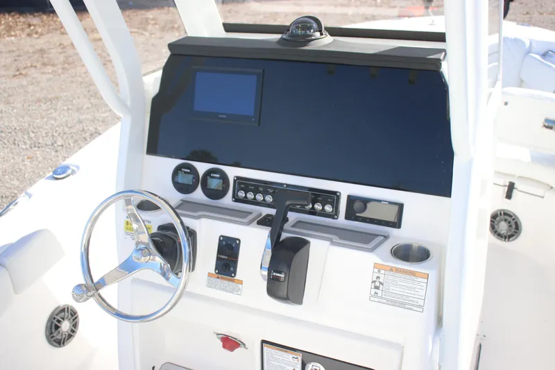 Slide: The Image of 2026 Sea Fox 228 Commander boat dashboard with steering wheel and control panel. - 17