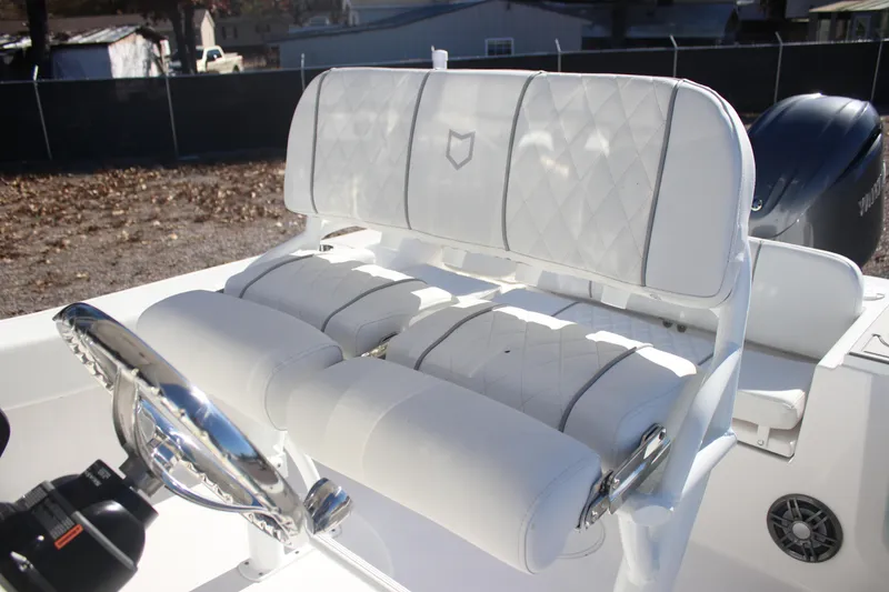 Slide: The Image of 2026 Sea Fox 228 Commander boat interior with white cushioned seating and steering wheel. - 20