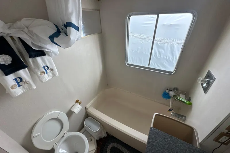Slide: The Image of Bathroom interior of 1985 Pearson 43 Trawler with window, toilet, and bathtub. - 12