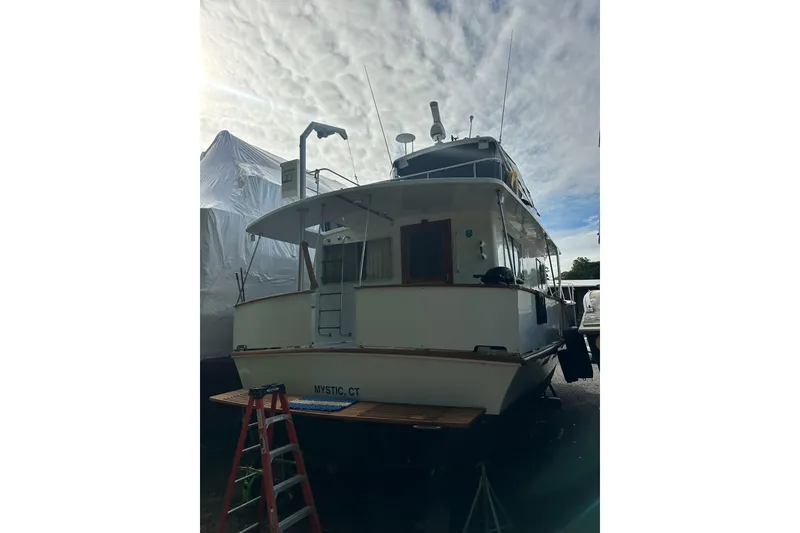 Slide: The Image of 1985 Pearson 43 Trawler docked in Mystic, CT under a cloudy sky. - 3