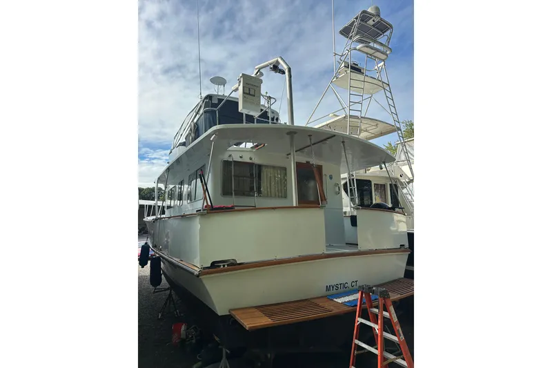 Slide: The Image of 1985 Pearson 43 Trawler docked, featuring a spacious deck and tower, located in Mystic, CT. - 4