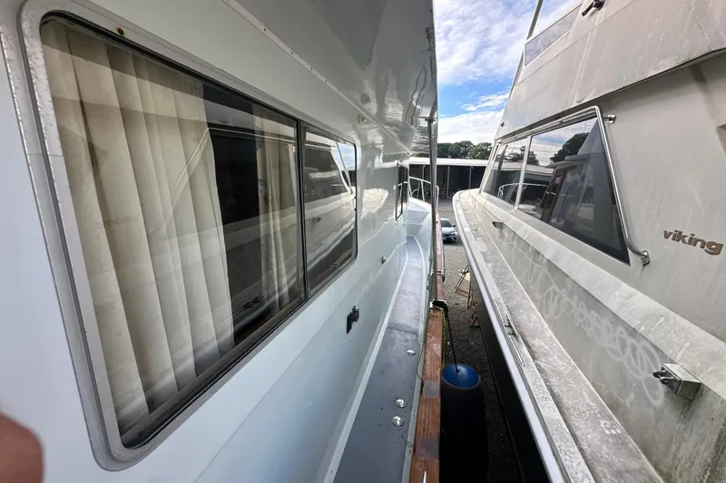 Slide: The Image of Side view of a 1985 Pearson 43 Trawler docked beside another boat. - 56