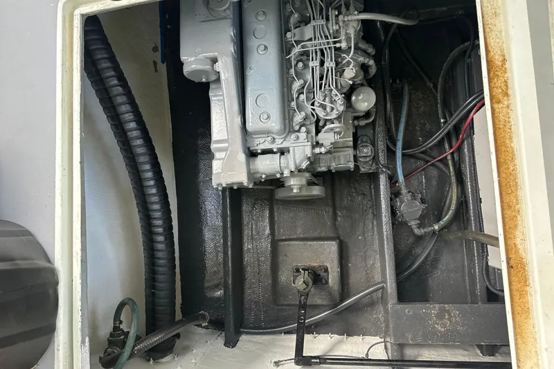 Slide: The Image of Engine compartment of a 1985 Pearson 43 Trawler, showing mechanical components and wiring. - 61