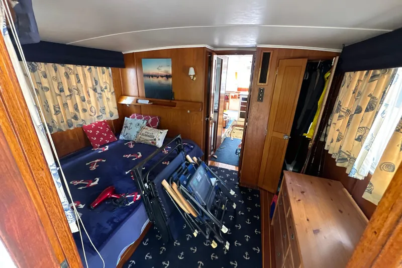 Slide: The Image of Cozy cabin interior of 1985 Pearson 43 Trawler with nautical decor and wooden furnishings. - 8