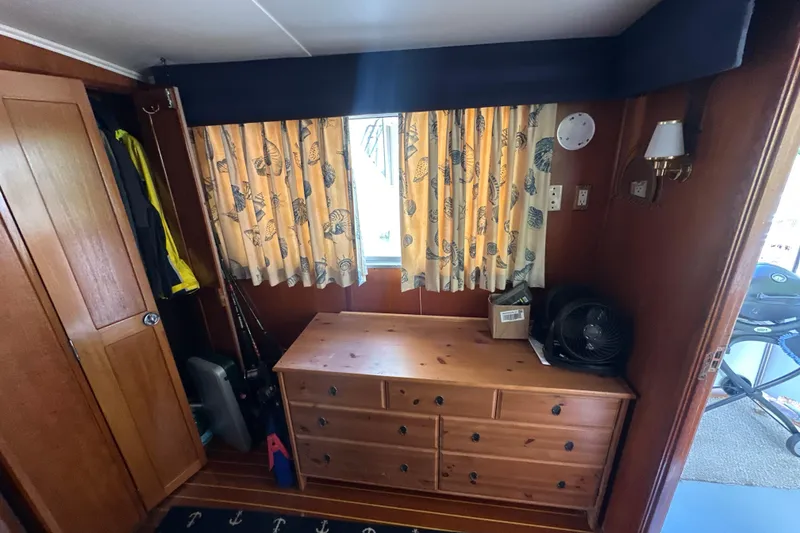 Slide: The Image of Interior of 1985 Pearson 43 Trawler with wooden dresser and nautical curtains. - 10