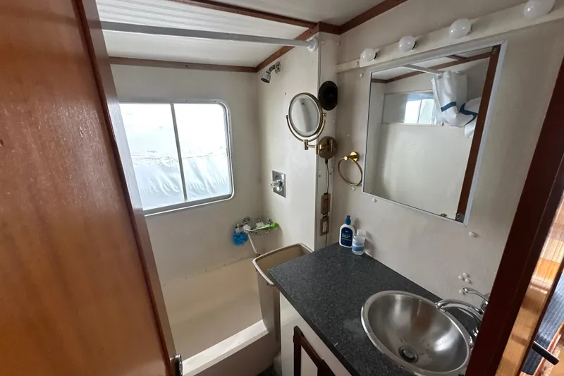 Slide: The Image of Bathroom interior of 1985 Pearson 43 Trawler with sink, mirror, and window. - 17