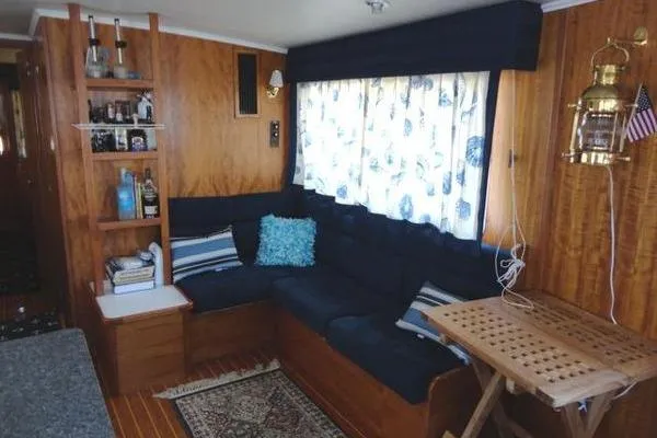 Slide: The Image of Cozy interior of 1985 Pearson 43 Trawler with wood paneling and nautical decor. - 19