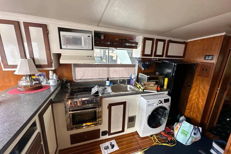 Slide: The Image of Interior of 1985 Pearson 43 Trawler kitchen with appliances and wooden cabinetry. - 20