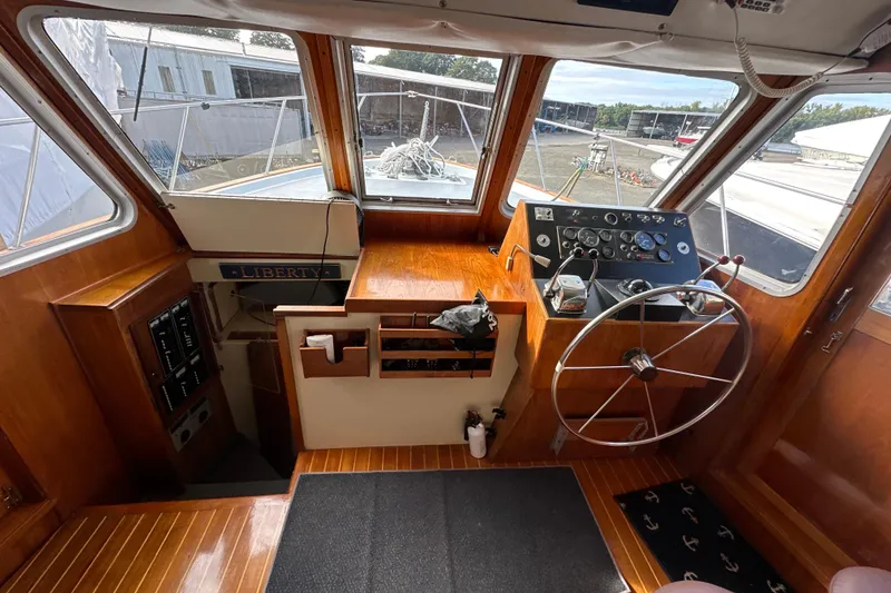 Slide: The Image of 1985 Pearson 43 Trawler helm with wooden interior and steering wheel. - 24