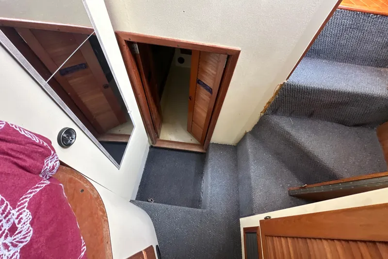 Slide: The Image of Interior view of 1985 Pearson 43 Trawler, featuring carpeted stairs and wooden doors. - 28
