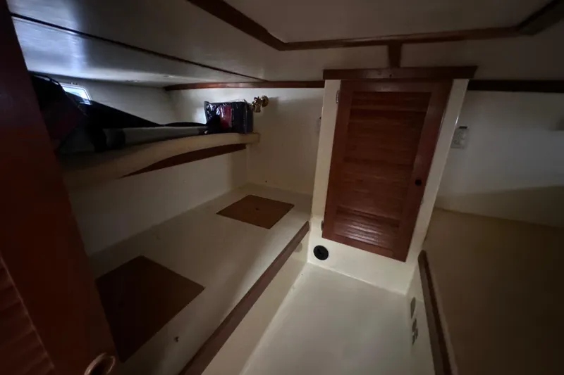 Slide: The Image of Interior cabin of 1985 Pearson 43 Trawler with wooden accents and storage space. - 29