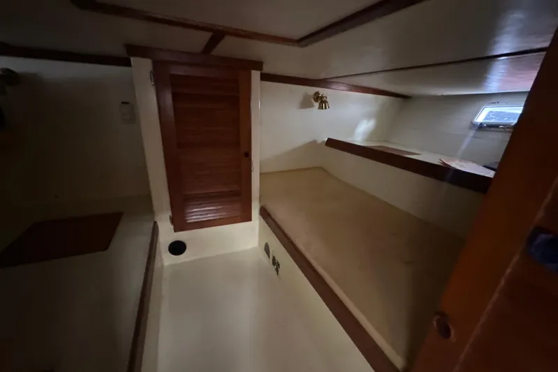 Slide: The Image of Interior cabin of 1985 Pearson 43 Trawler with wooden door and bunk bed. - 30