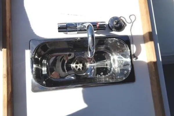 Slide: The Image of Stainless steel sink on 1985 Pearson 43 Trawler boat, featuring modern faucet design. - 43