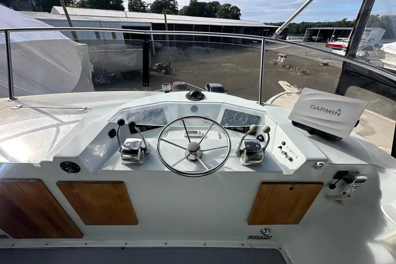 Slide: The Image of Cockpit of 1985 Pearson 43 Trawler with Garmin navigation system and steering wheel. - 46