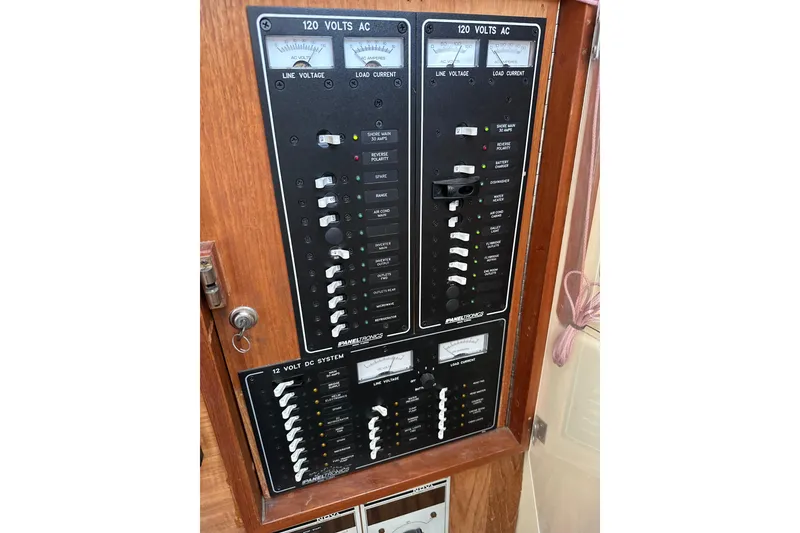 Slide: The Image of Electrical panel on a 1985 Pearson 43 Trawler, featuring 120V AC and 12V DC systems. - 58
