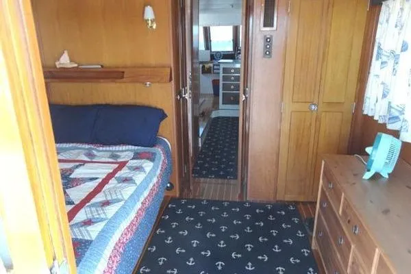 Slide: The Image of Interior of 1985 Pearson 43 Trawler with cozy bedroom and nautical decor. - 6
