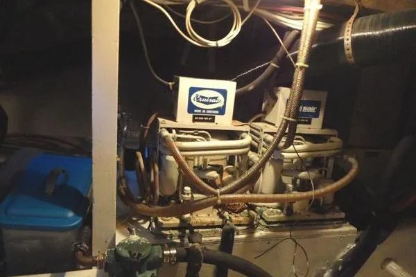 Slide: The Image of Engine room of a 1985 Pearson 43 Trawler with visible machinery and wiring. - 67