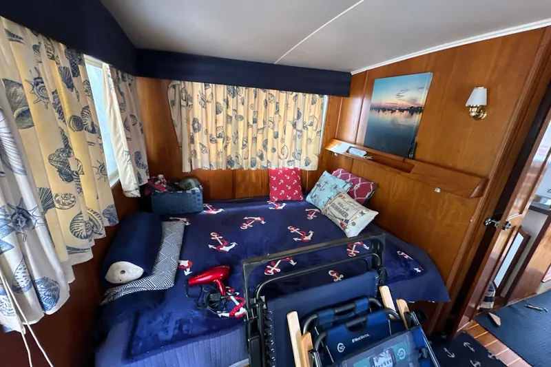 Slide: The Image of Cozy cabin interior of 1985 Pearson 43 Trawler with nautical-themed decor and wooden paneling. - 9
