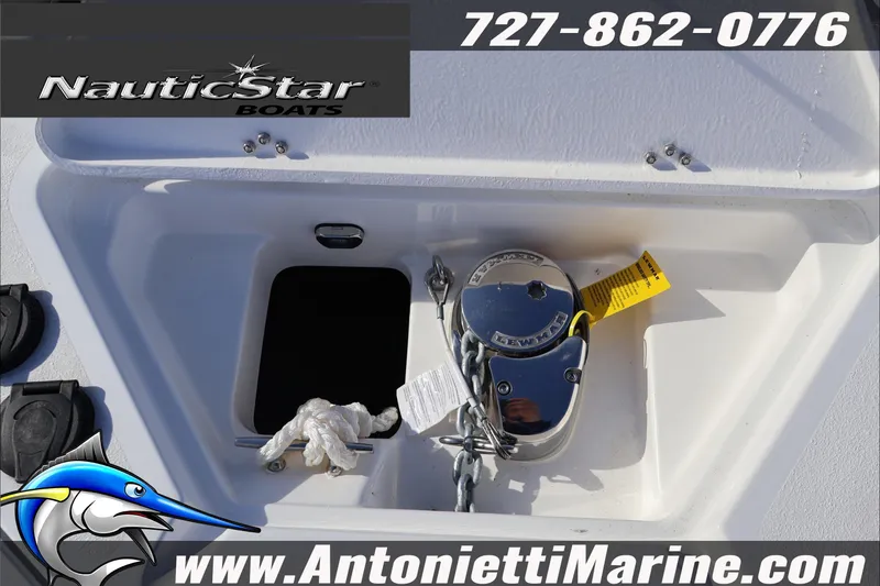 Slide: The Image of NauticStar 251 Hybrid boat anchor compartment with contact details and logo. - 11
