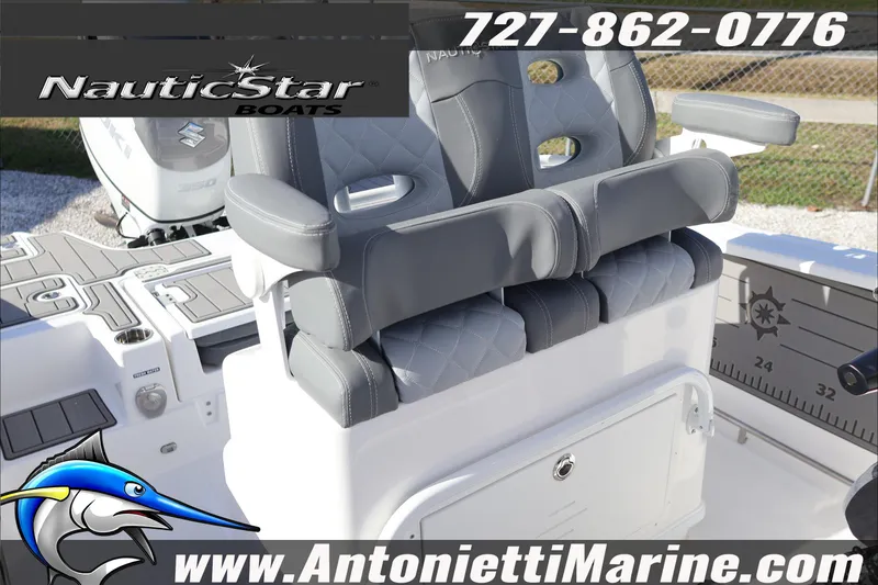 Slide: The Image of 2026 NauticStar 251 Hybrid boat interior with gray seating, logo, and contact information. - 24