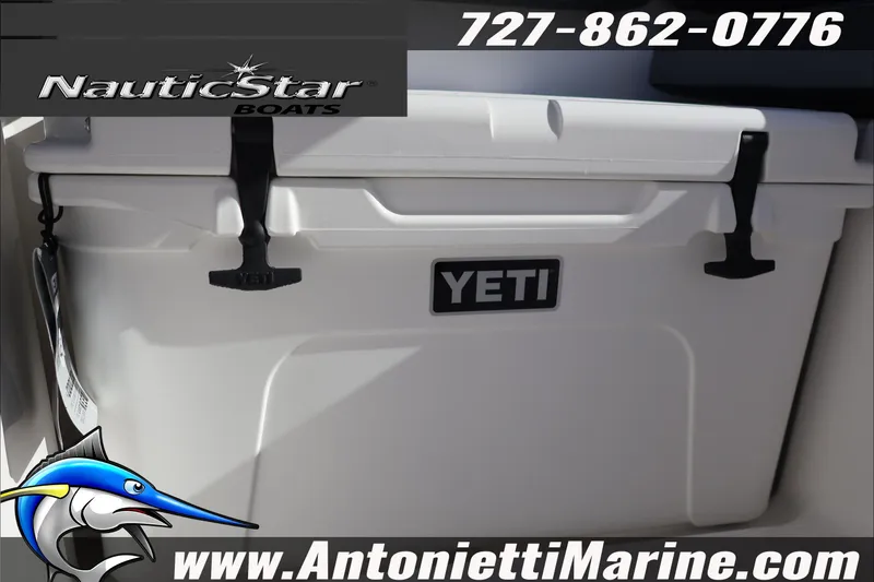 Slide: The Image of YETI cooler on NauticStar 251 Hybrid boat, 2026 model, with contact details and logo. - 36