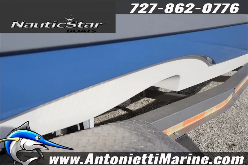Slide: The Image of 2026 NauticStar 251 Hybrid boat on trailer, featuring sleek blue and white design. - 6
