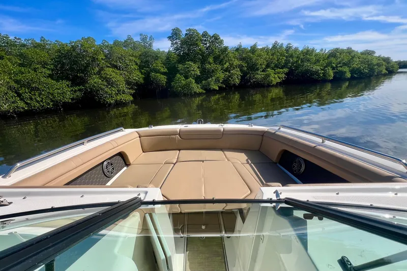 Slide: The Image of 2019 Sea Ray SDX 290 Outboard boat with spacious seating, cruising on calm waters. - 14