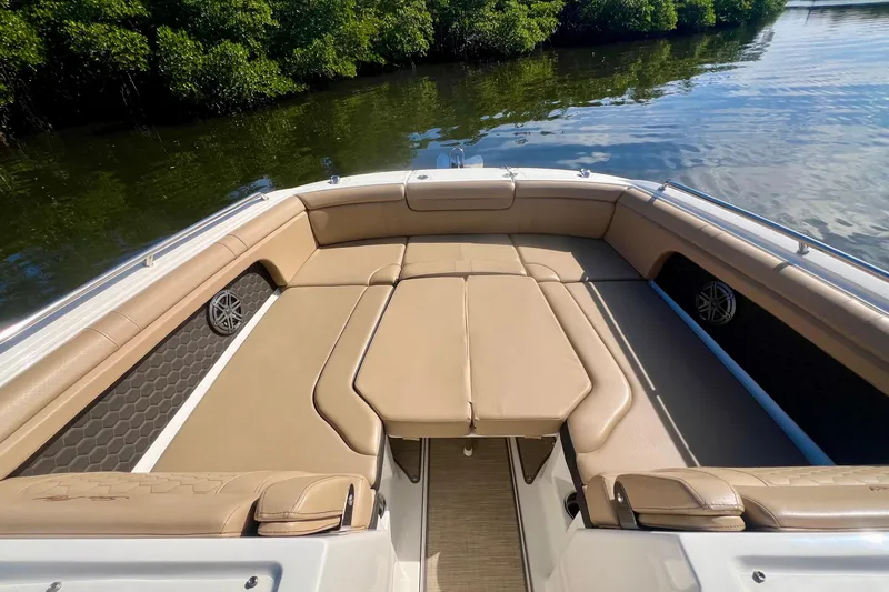 Slide: The Image of 2019 Sea Ray SDX 290 Outboard boat with spacious tan seating and scenic water view. - 15