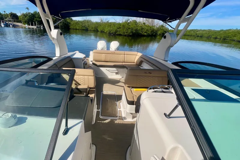 Slide: The Image of 2019 Sea Ray SDX 290 Outboard boat interior with seating, on a calm lake. - 16