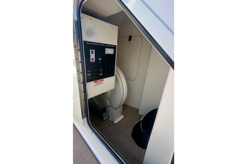 Slide: The Image of 2019 Sea Ray SDX 290 Outboard interior control panel and storage area. - 25