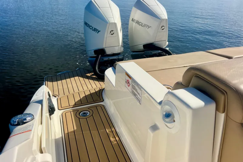 Slide: The Image of 2019 Sea Ray SDX 290 Outboard with twin Mercury engines on calm water. - 26