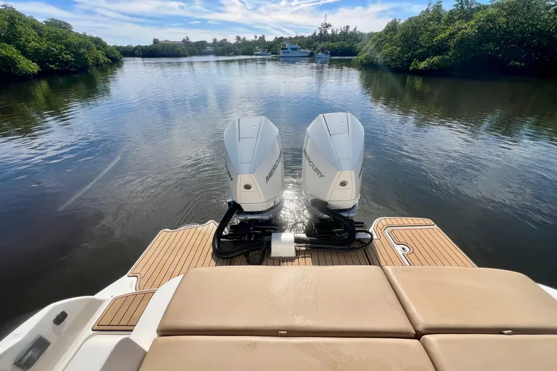 Slide: The Image of 2019 Sea Ray SDX 290 Outboard on calm water with twin Mercury engines. - 27